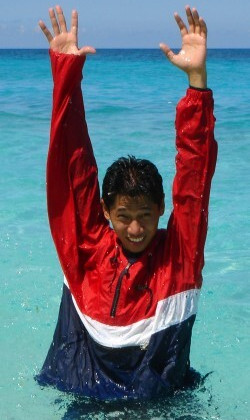 Lifeguard signals both hands up danger